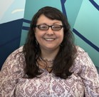 A woman smiling for the camera.