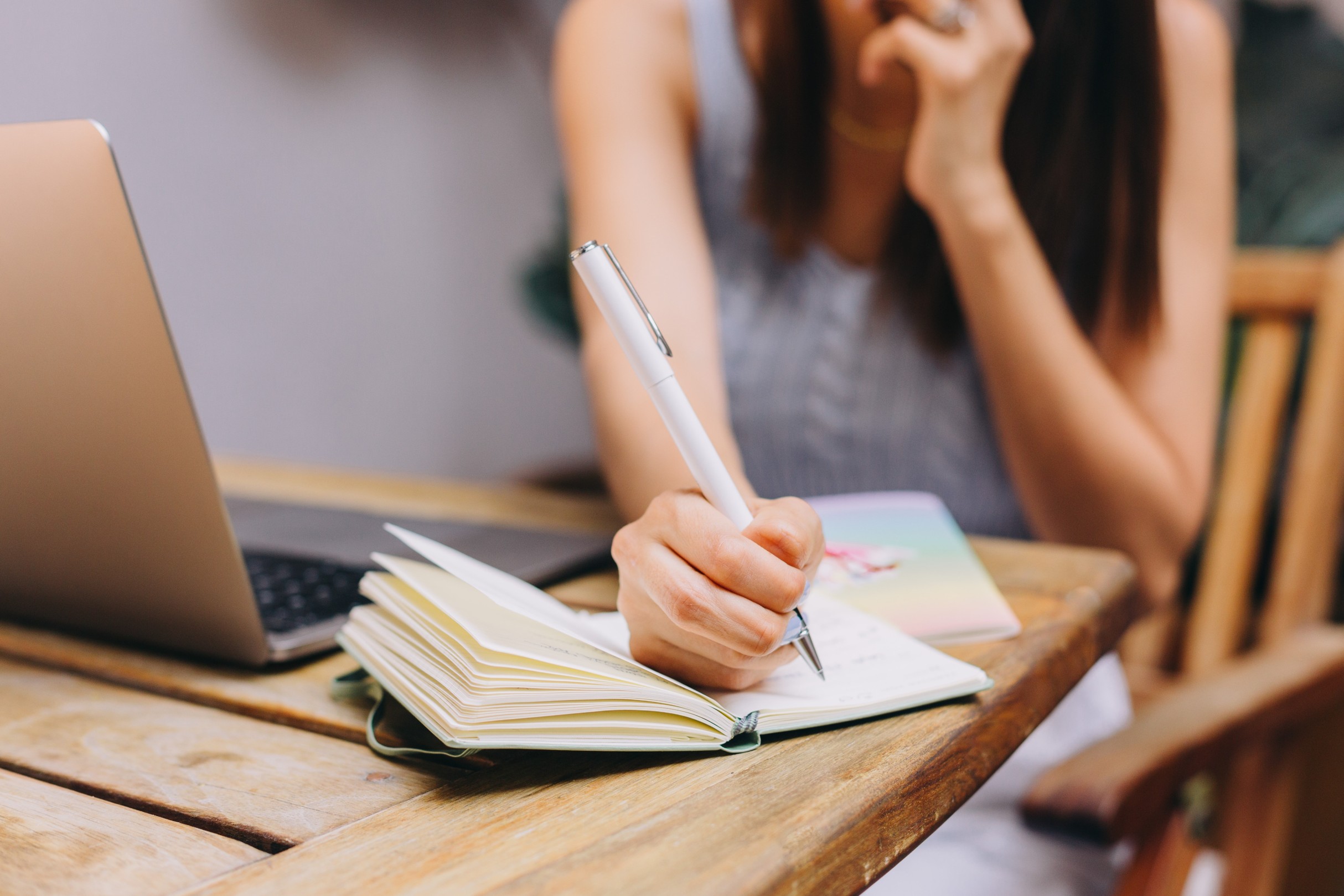 A woman writing on a piece of paper.