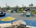 A skate park with a bike and rocks.