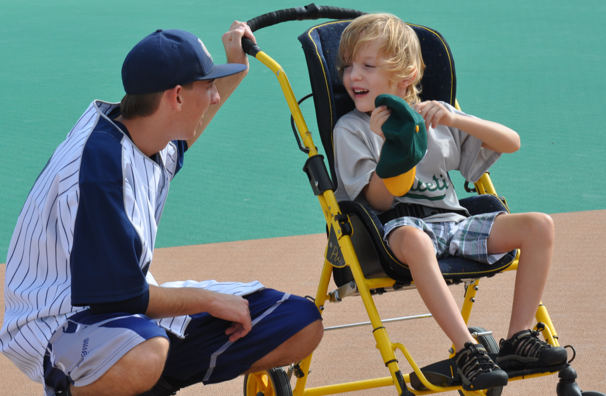 A person and a boy sitting in a chair.