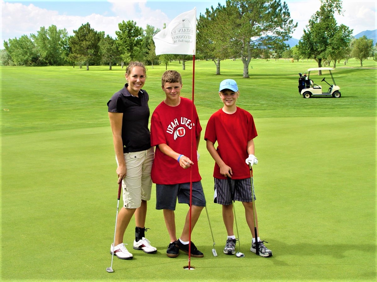 A group of men posing for a picture on a golf course.