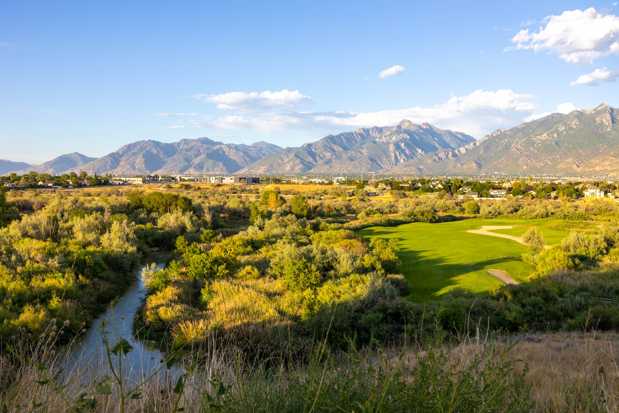 A river running through a beautiful landscape alongside Riverbend Golf Course in Salt Lake City.