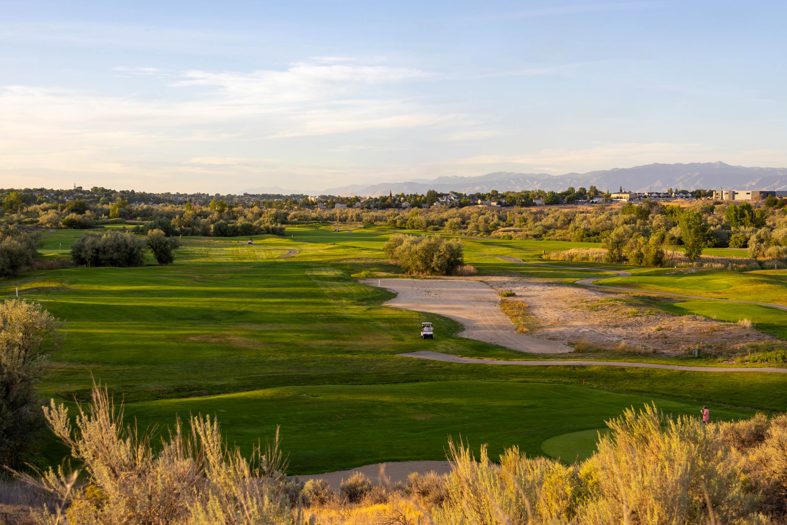 A large view of multiple fairways and landscaping at Riverbend Golf Course in Riverton, Utah.
