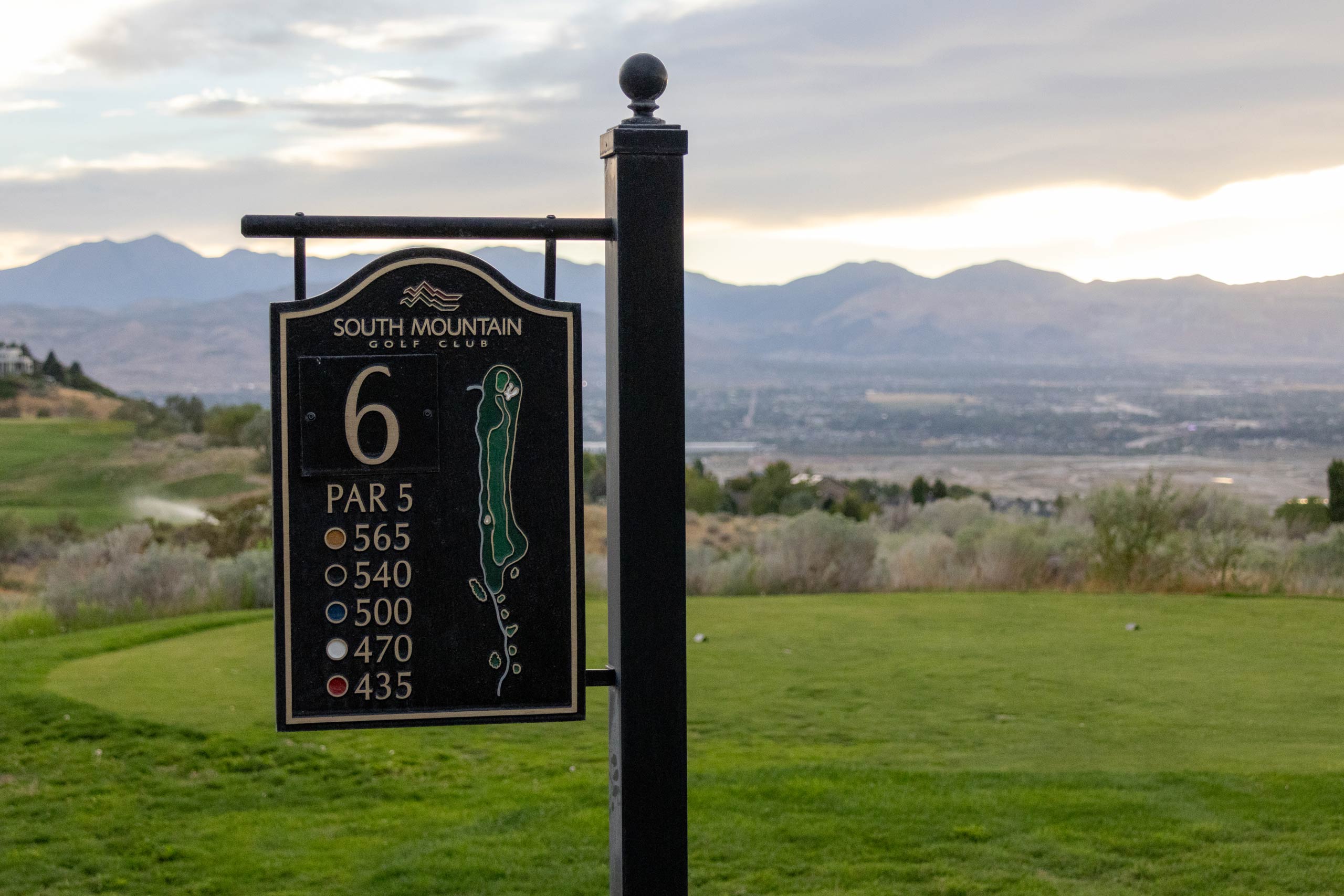 Hole 6 sign on South Mountain golf course in Salt Lake City with golf tee and mountains in the background.