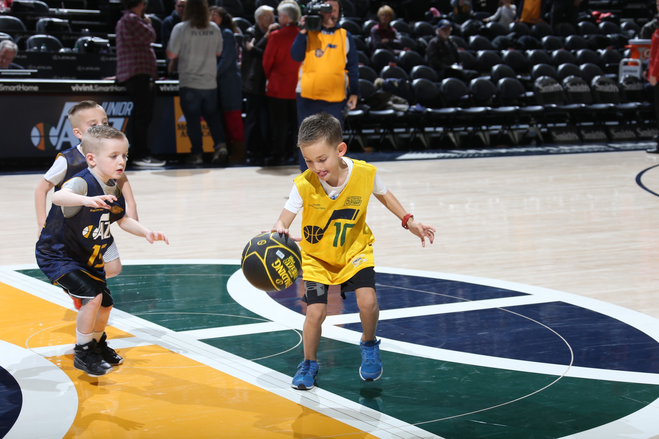 A couple of boys playing basketball.